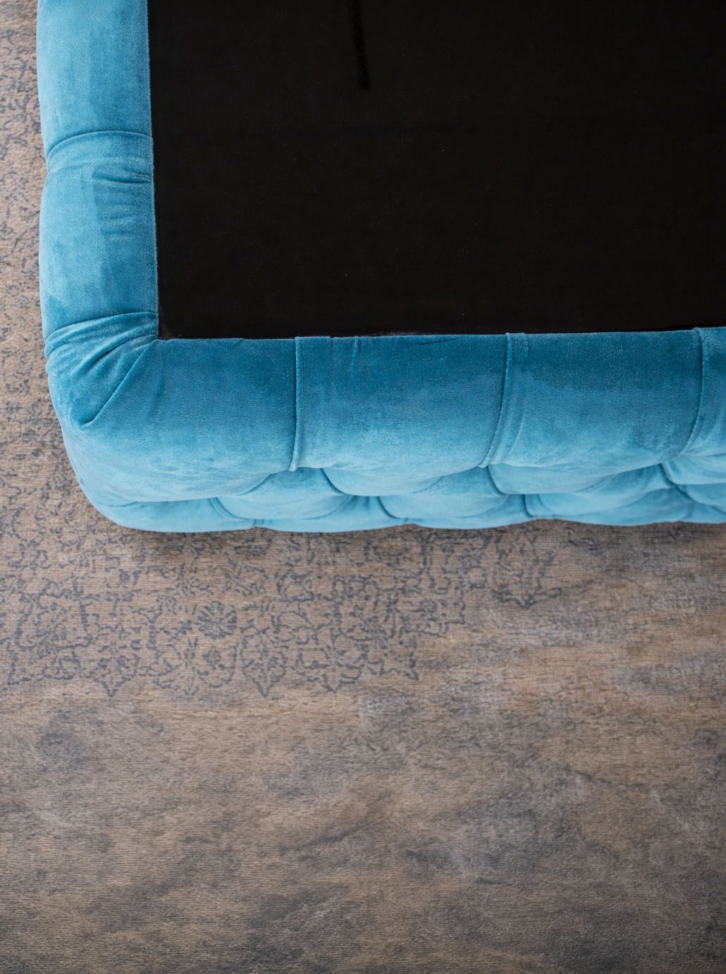 Xtreme coffee table by IMPACT MOB, featuring a velvet upholstery and sleek design, set in a modern living room.